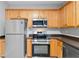 Modern kitchen with stainless steel appliances and ample wood cabinet space at 129 Prospect Path, Hiram, GA 30141