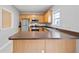 Well-lit kitchen features stainless appliances, wooden cabinets, and a breakfast bar at 129 Prospect Path, Hiram, GA 30141