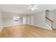 A large living room has an open floor plan and wood laminate floors at 129 Prospect Path, Hiram, GA 30141
