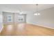 Open living area with natural light, wood-look floors, and a modern pendant light at 129 Prospect Path, Hiram, GA 30141