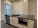 Close up of a kitchen island with a stainless steel sink, microwave and grey countertop at 1313 Breezy Street # 131, Atlanta, GA 30315