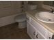 Bathroom featuring a tub, toilet, and vanity sink with storage space at 1404 Bailey Sw, Conyers, GA 30094