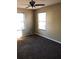 Bedroom with two windows, a ceiling fan, and neutral-colored carpet at 1404 Bailey Sw, Conyers, GA 30094