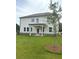The backyard has a covered patio and lush green lawn at 1847 Kingsmere Run Dr, Loganville, GA 30052