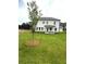 Lush green backyard with a newly planted tree and open space at 1847 Kingsmere Run Dr, Loganville, GA 30052