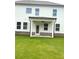The backyard has a covered patio and lush green lawn at 1847 Kingsmere Run Dr, Loganville, GA 30052