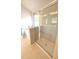 Modern glass enclosed shower with tiled walls and a bathtub at 1847 Kingsmere Run Dr, Loganville, GA 30052