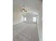 Bright, carpeted bedroom features neutral walls, a vaulted ceiling, and a modern ceiling fan at 1847 Kingsmere Run Dr, Loganville, GA 30052