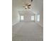 A bright and airy bedroom with plush carpeting features a ceiling fan and neutral paint at 1847 Kingsmere Run Dr, Loganville, GA 30052