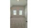 This is a spacious bedroom with neutral carpeting, two windows, and white walls at 1847 Kingsmere Run Dr, Loganville, GA 30052