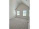 This is a spacious bedroom with neutral walls and carpeting, and large windows at 1847 Kingsmere Run Dr, Loganville, GA 30052