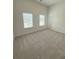 Spacious bedroom with neutral carpeting, two windows and white walls at 1847 Kingsmere Run Dr, Loganville, GA 30052