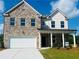 Charming two-story home with a brick facade, white siding, and a well-maintained lawn at 1847 Kingsmere Run Dr, Loganville, GA 30052
