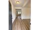 Open foyer with wood-look flooring leads to the living area and staircase at 1847 Kingsmere Run Dr, Loganville, GA 30052