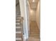 Hallway with wood-look floors leading to a storage area near the staircase at 1847 Kingsmere Run Dr, Loganville, GA 30052