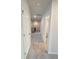 Upstairs hallway has neutral carpeting, white walls, and white doors at 1847 Kingsmere Run Dr, Loganville, GA 30052