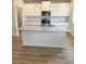 Kitchen featuring a granite island, stainless steel appliances and ample cabinetry at 1847 Kingsmere Run Dr, Loganville, GA 30052
