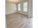 Bright living room featuring wood-look floors and a modern chandelier at 1847 Kingsmere Run Dr, Loganville, GA 30052