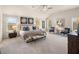 Spacious main bedroom featuring neutral tones, plush carpeting, a ceiling fan, and plenty of natural light at 1847 Kingsmere Run Dr, Loganville, GA 30052