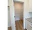 Walk-in pantry featuring built-in wire shelving and wood-look floors at 1847 Kingsmere Run Dr, Loganville, GA 30052