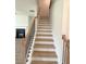 The staircase features black wrought iron railings and stained wood stairs at 1847 Kingsmere Run Dr, Loganville, GA 30052