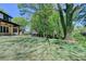View of the house from the backyard with green grass and trees at 270 New Hope Rd, Lawrenceville, GA 30046