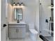 Neutral bathroom featuring single sink vanity, framed mirror, and walk-in shower with glass door at 270 New Hope Rd, Lawrenceville, GA 30046