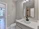 Neutral bathroom features a single sink vanity with a white countertop and a large mirror at 270 New Hope Rd, Lawrenceville, GA 30046