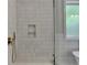 Close-up of a shower featuring white tile, gold fixtures, and a built-in niche at 270 New Hope Rd, Lawrenceville, GA 30046