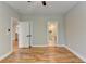 Bedroom with hardwood floors, white doors, and a view into a tiled bathroom at 270 New Hope Rd, Lawrenceville, GA 30046