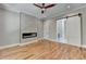 Bedroom featuring hardwood floors, a modern fireplace, a sliding barn door, and recessed lighting at 270 New Hope Rd, Lawrenceville, GA 30046