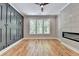 Bright bedroom featuring hardwood floors, modern fireplace, a statement wall and three large windows at 270 New Hope Rd, Lawrenceville, GA 30046