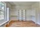 Spacious walk-in closet with built-in shelving and hardwood floors at 270 New Hope Rd, Lawrenceville, GA 30046