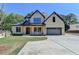 Stunning two-story home with a light brick facade, dark trim, and a spacious driveway and lush landscaping at 270 New Hope Rd, Lawrenceville, GA 30046