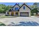 Stunning two-story home with a light brick facade, dark trim, and a spacious driveway and lush landscaping at 270 New Hope Rd, Lawrenceville, GA 30046