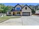 Stunning two-story home with a light brick facade, dark trim, and a spacious driveway and lush landscaping at 270 New Hope Rd, Lawrenceville, GA 30046
