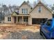 New two-story brick home with a spacious two-car garage, front porch and unfinished landscaping at 270 New Hope Rd, Lawrenceville, GA 30046