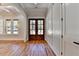 Elegant foyer with beautiful hardwood floors, a double wood door, and white trim at 270 New Hope Rd, Lawrenceville, GA 30046