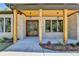Inviting front porch featuring a double wood door, wooden columns, and decorative hanging lanterns at 270 New Hope Rd, Lawrenceville, GA 30046