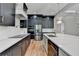 Modern kitchen with stainless steel appliances, dark cabinets, and white countertops at 270 New Hope Rd, Lawrenceville, GA 30046