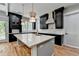 Modern kitchen with dark cabinets, white countertops, a large island, and stainless steel appliances at 270 New Hope Rd, Lawrenceville, GA 30046