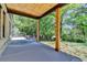 Covered patio with exposed wood beams, stained wood pillars, and spacious design at 270 New Hope Rd, Lawrenceville, GA 30046
