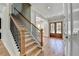 Staircase with wood floors, wooden and wrought iron railing, and view of entryway at 270 New Hope Rd, Lawrenceville, GA 30046