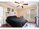 Bedroom featuring a decorative fan, a dark comforter, and shuttered windows at 3175 Seven Pines Ct # 207, Atlanta, GA 30339