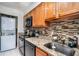 Updated kitchen featuring stainless steel appliances, granite countertops, tile backsplash and stacked washer/dryer at 3175 Seven Pines Ct # 207, Atlanta, GA 30339