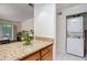 Galley kitchen with granite countertops, stackable washer/dryer, and updated appliances at 3175 Seven Pines Ct # 207, Atlanta, GA 30339
