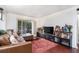 Living room featuring a leather sectional sofa, rug, and display shelves with a door to the outside at 3175 Seven Pines Ct # 207, Atlanta, GA 30339