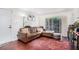 Cozy living room showcasing a stylish brown sectional and natural light from the window at 3175 Seven Pines Ct # 207, Atlanta, GA 30339