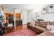 Open living room and kitchen area featuring a leather sectional sofa, rug, breakfast bar and display shelves at 3175 Seven Pines Ct # 207, Atlanta, GA 30339