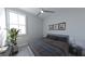 Cozy bedroom featuring a bright window, calming gray walls and simple decor at 672 Soul Aly, Alpharetta, GA 30009